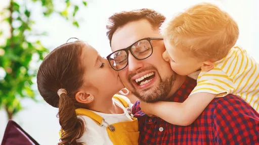 a bearded man gets a big hug from 2 small kids