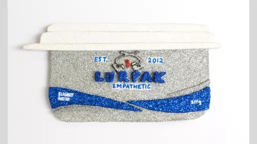 Glitter and markers on Paper presentation board artwork of a Lurpak butter container