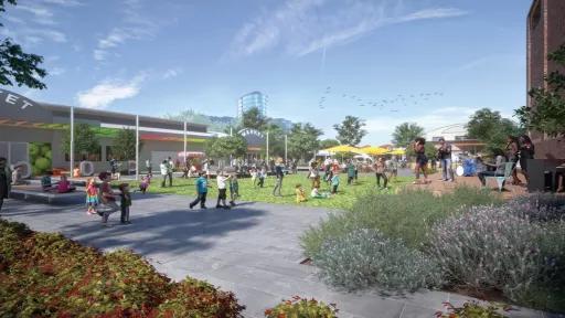 People walking around a paved and grassy open area in front of Camberwell Market