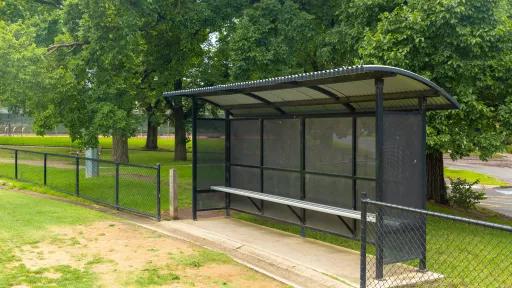 A covered bench seat in a park