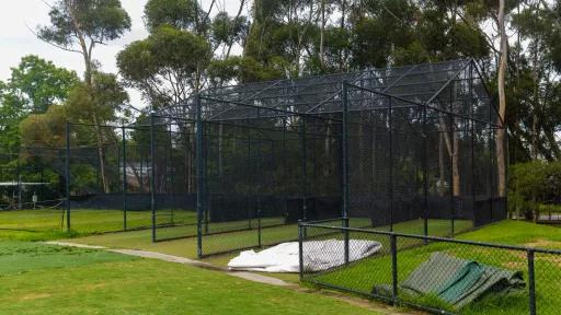 Cricket nets at a sportsground with trees in the background