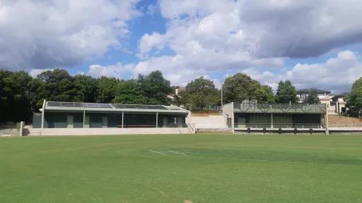 Two pavilions with tiered seating at a sportsground