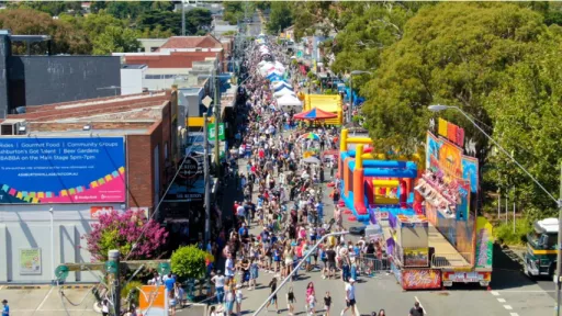 Overhead photo shows crowds of people on shop-lined street